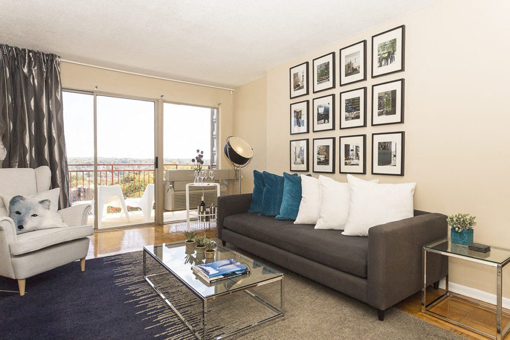 a living room with a couch and a glass coffee table