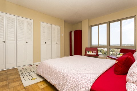 a bedroom with a bed and windows