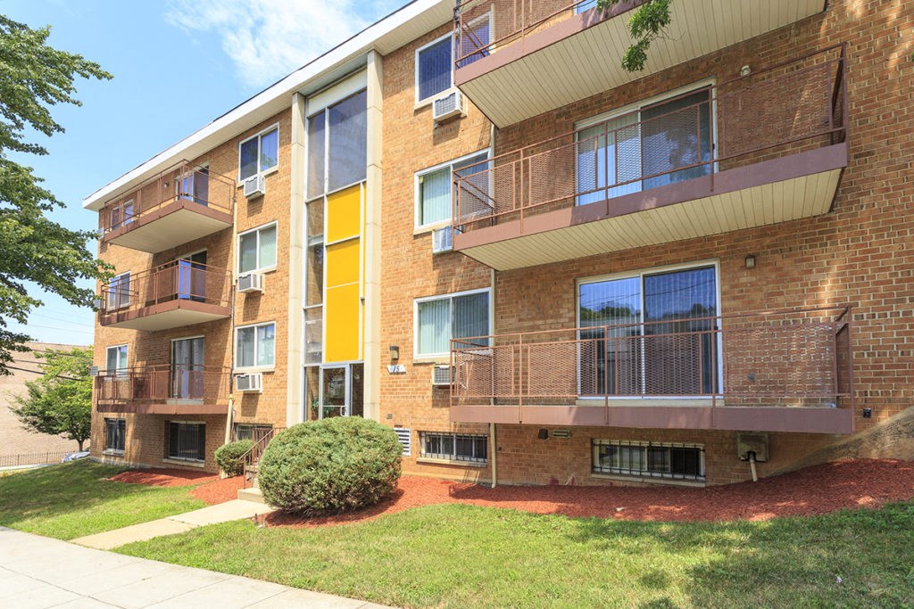 exterior view of a brick apartment building with balconies