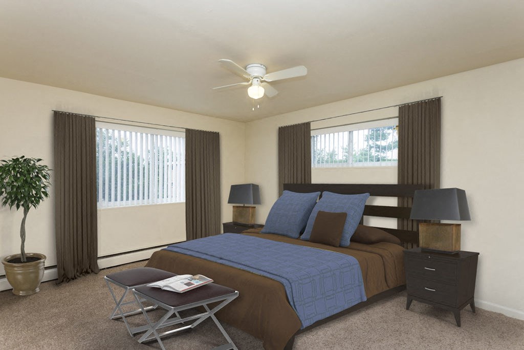 a bedroom with a bed and a ceiling fan