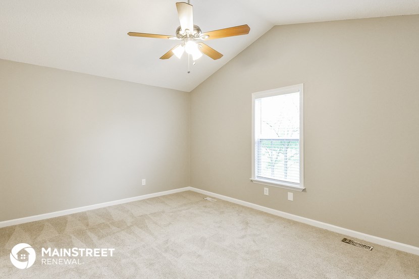 the master bedroom is spacious and has a ceiling fan