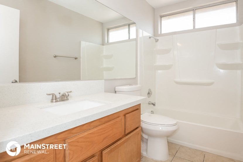a bathroom with a toilet and a sink and a mirror
