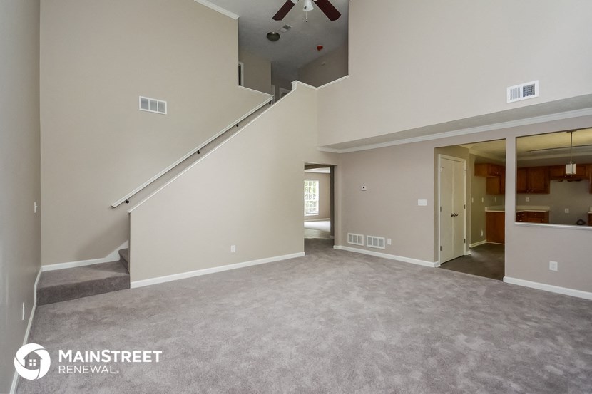 the spacious living room with staircase to the loft