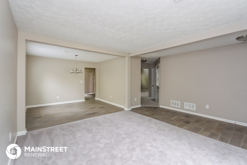 the spacious living room and dining room in a 3673 sq ft home