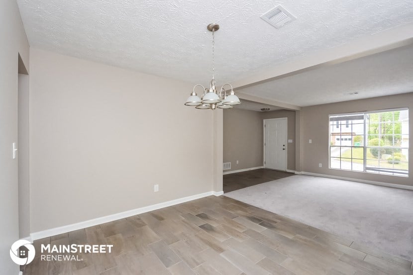 the living room and dining room of an empty renovated house