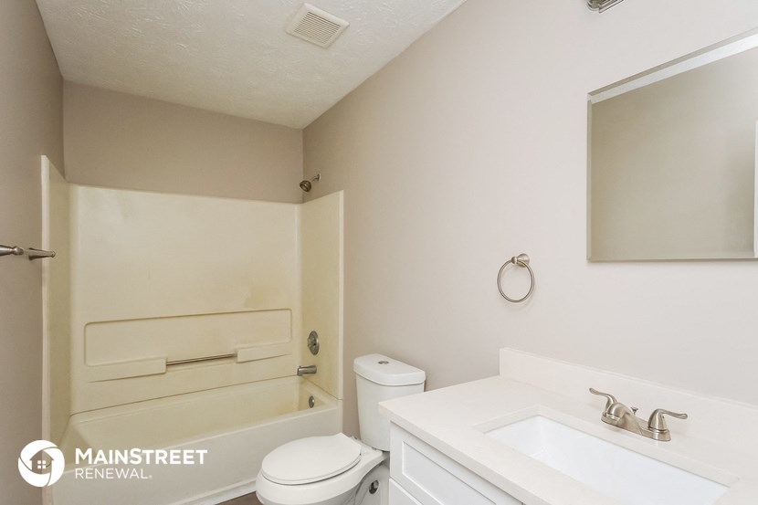 a bathroom with a sink toilet and a bath tub