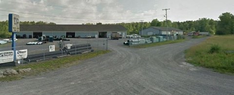 a dirt road in front of a building
