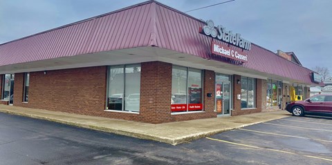 the front of a restaurant with a car parked outside