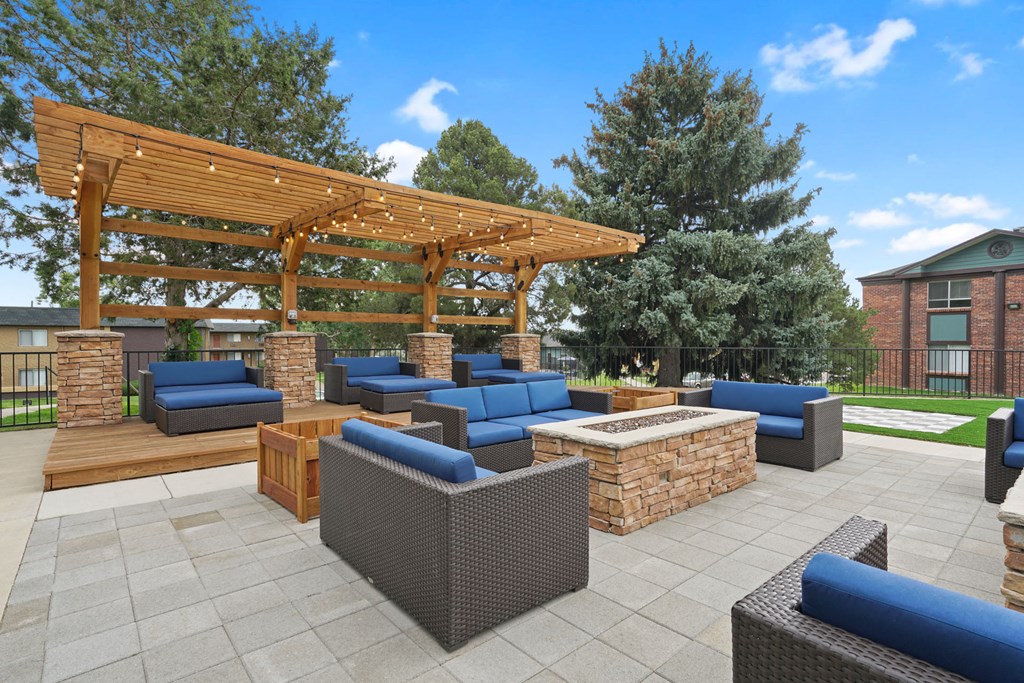 a rendering of a patio with a fire pit and a wooden pergola