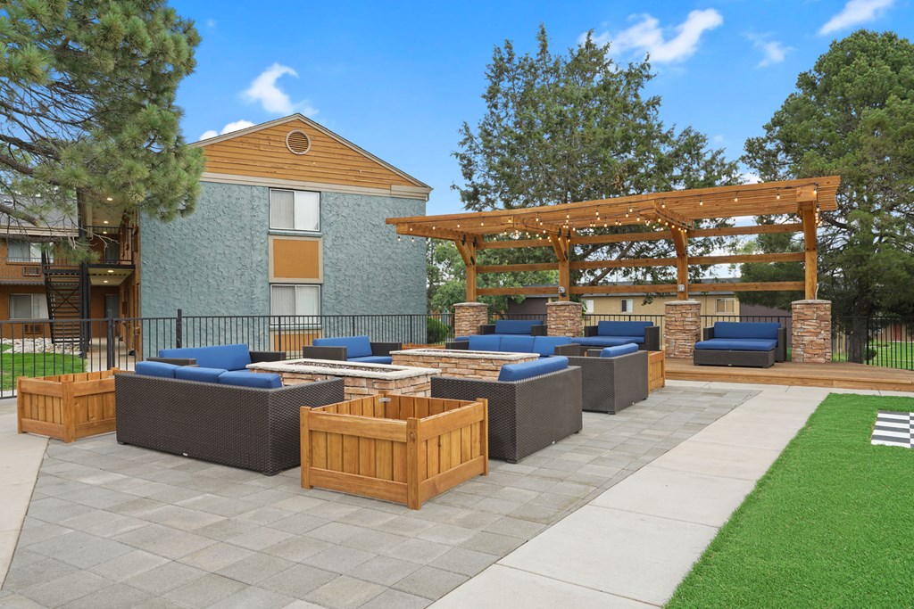 a patio with couches and a pergola