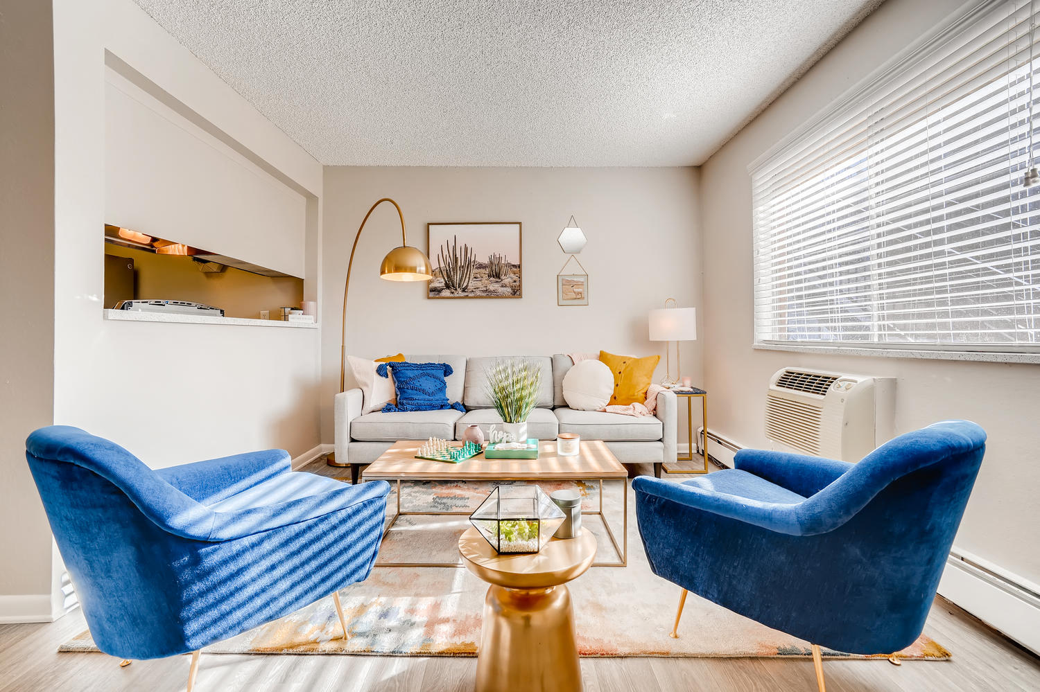 a living room with blue chairs and a couch