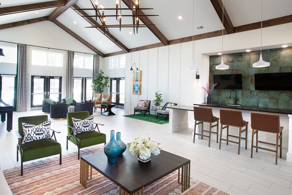 a living room with a table and chairs and a kitchen