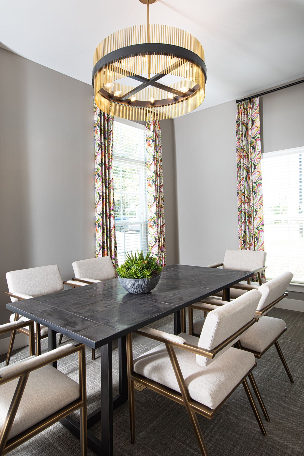 a dining room with a table and chairs and a large chandelier