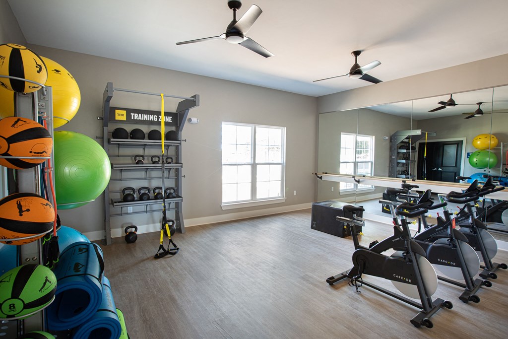 a workout room with exercise equipment and mirrors in a new home
