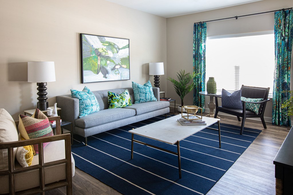 a living room with a blue rug and a couch