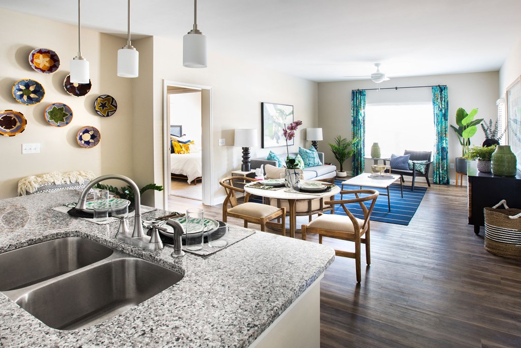 a living room with a kitchen and a dining room