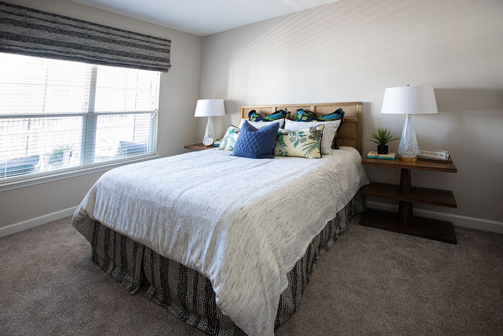 a bedroom with a bed and a window