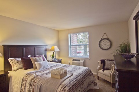 a bedroom with a bed and a clock on the wall