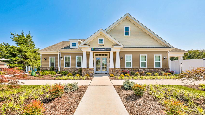 the front of a house with a sidewalk in front of it