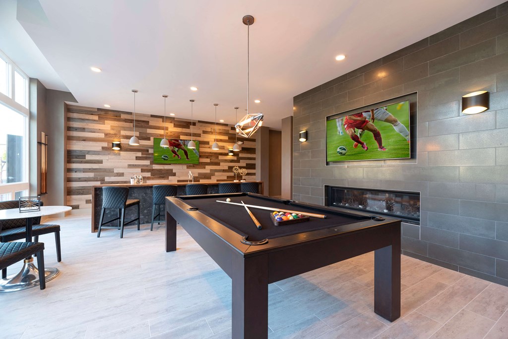a games room with a pool table and a television