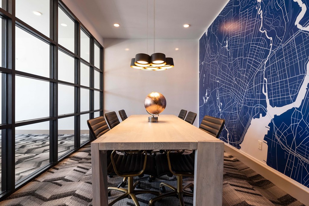 a conference room with a table and chairs and a map on the wall