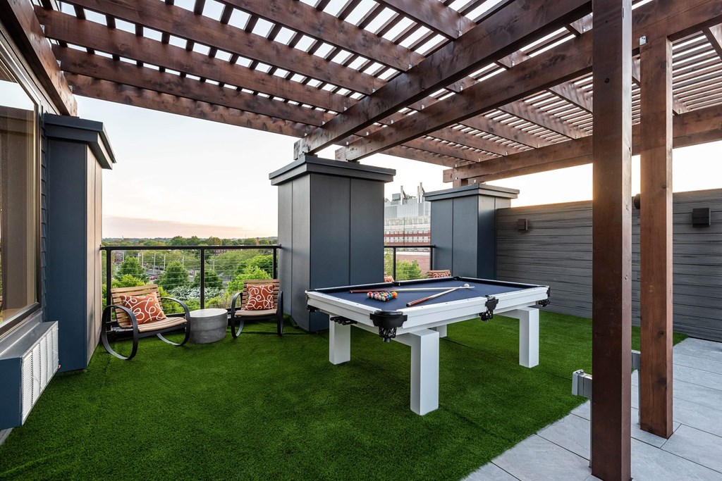 a backyard with a pool table and a pergola