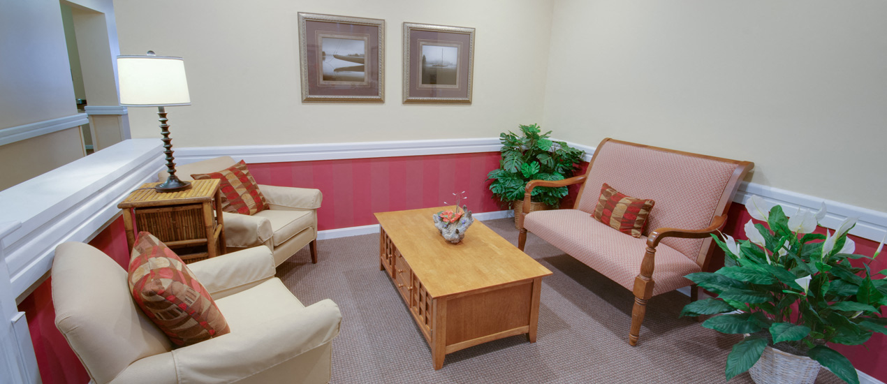 a living room with chairs and a table