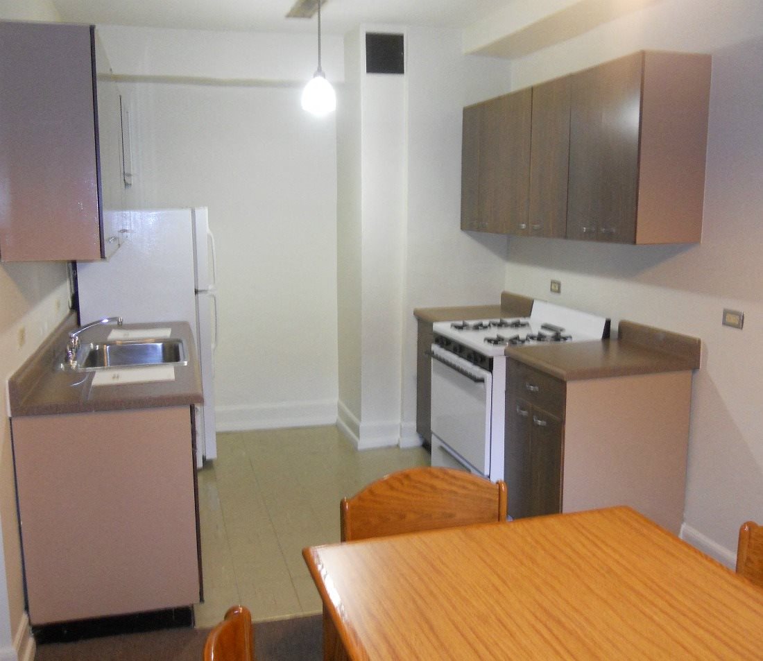a kitchen and dining room with a wooden table