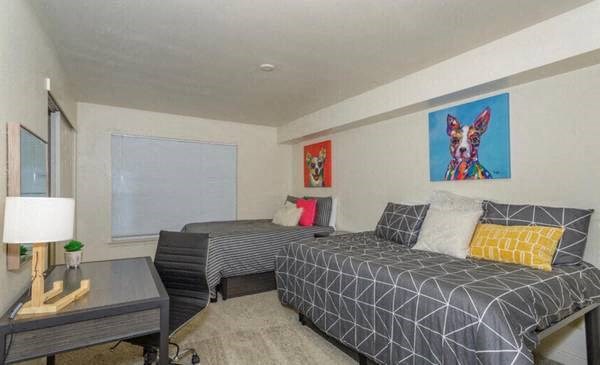 a hotel room with two beds and a table