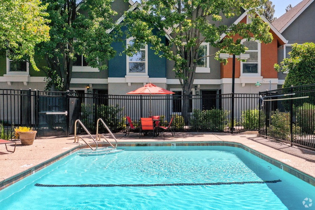 a swimming pool in front of an apartment building
