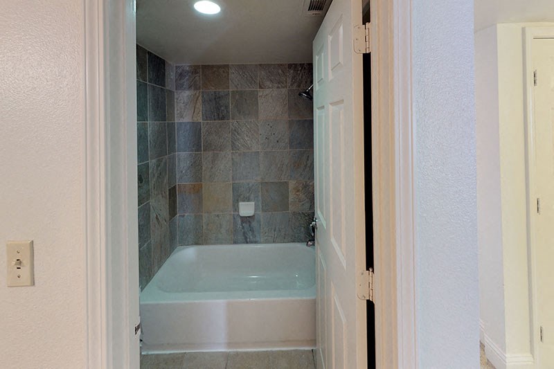 a small bathroom with a tub and a shower