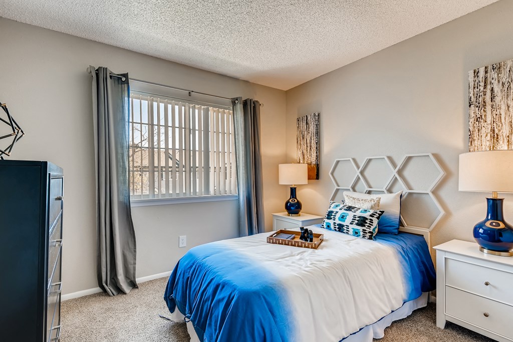 the master bedroom has a comfy bed and a large window