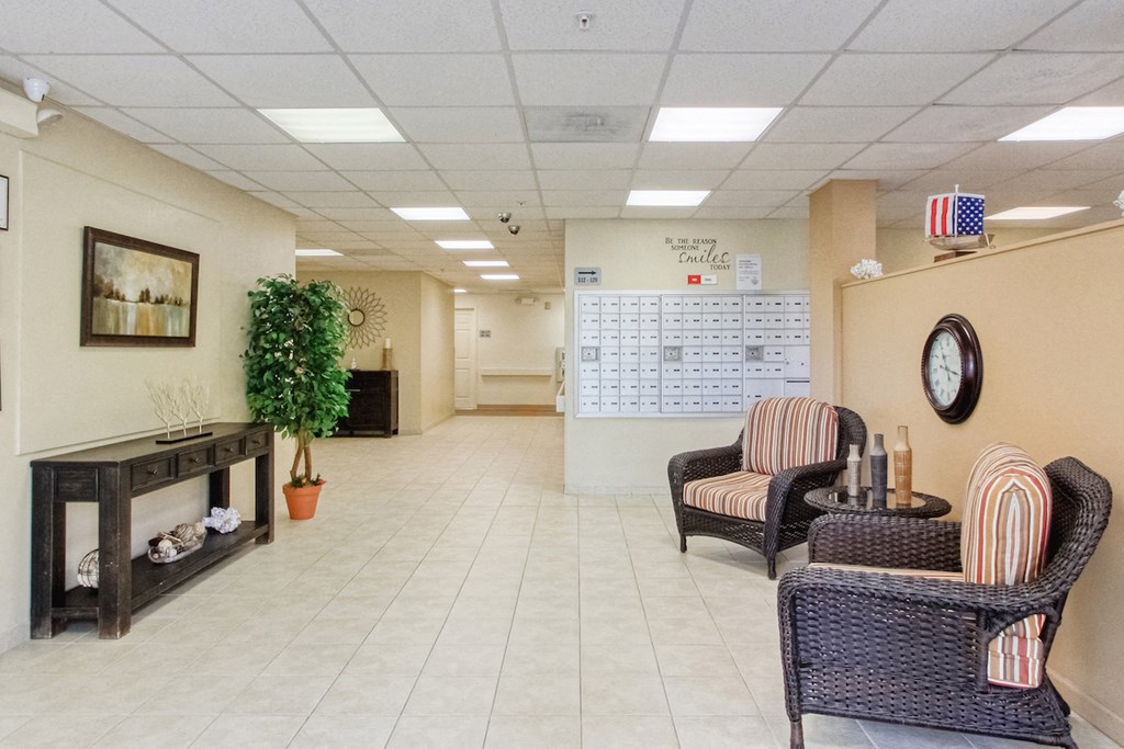 Lobby with chairs, clock, decor, and resident malbox bank