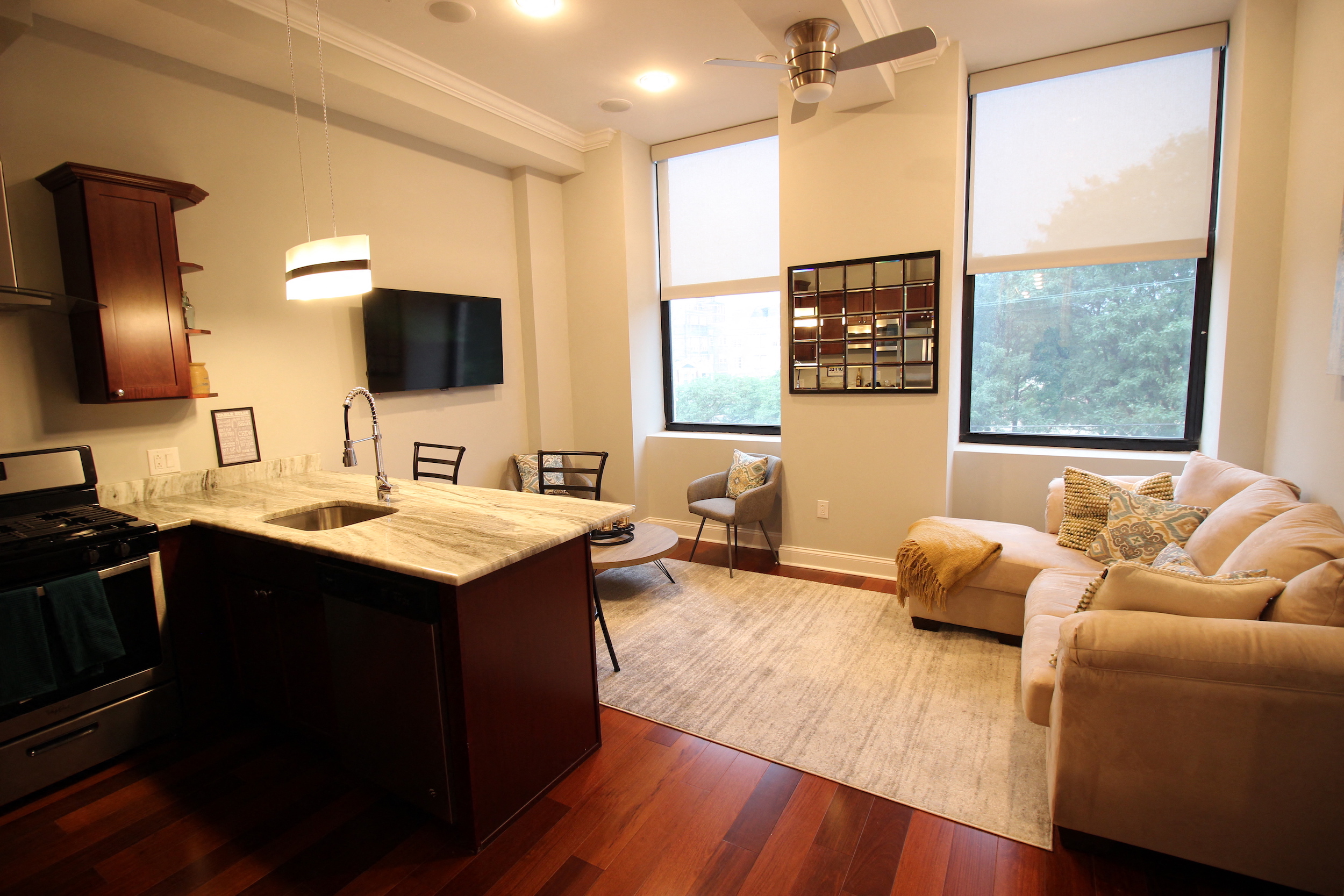 a kitchen and living room with a couch and a tv
