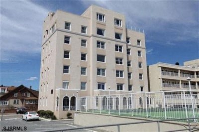 a white building with a fence in front of it