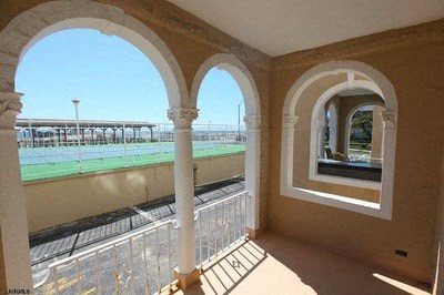 a balcony with a view of a body of water