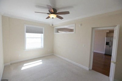 an empty living room with a ceiling fan