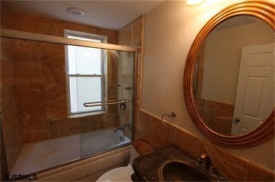 a bathroom with a mirror and a sink and a tub