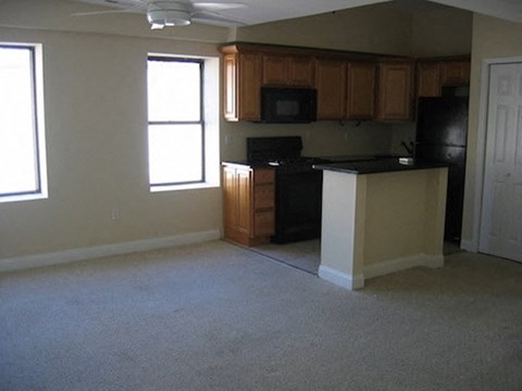 an empty kitchen with an island in the middle of it