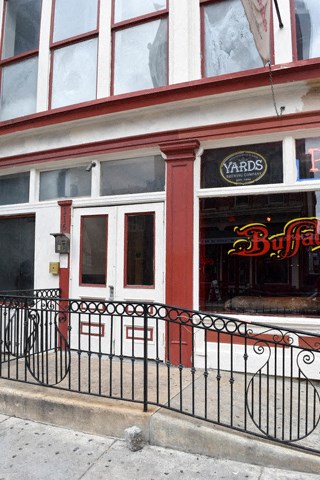 a building with a bar and a fence in front of it