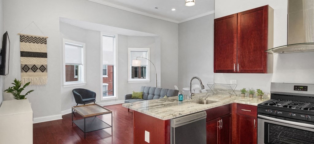 a kitchen with a sink and a stove and a window