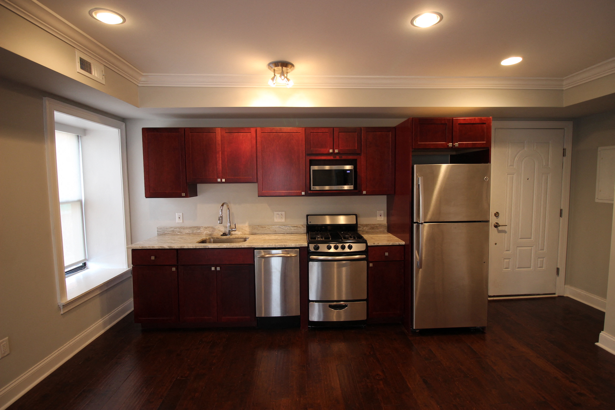 a kitchen with wooden cabinets and stainless steel appliances