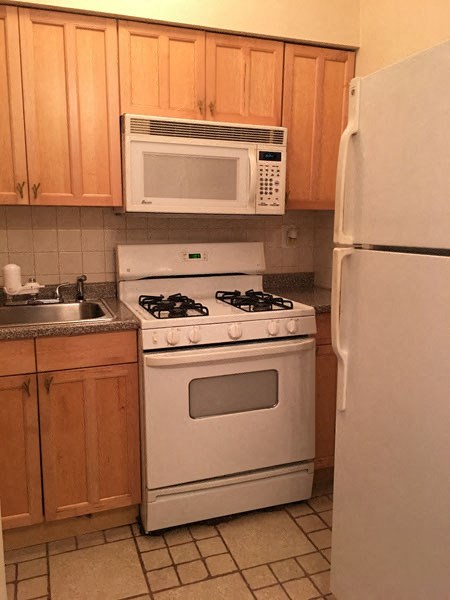 a kitchen with a stove microwave and refrigerator