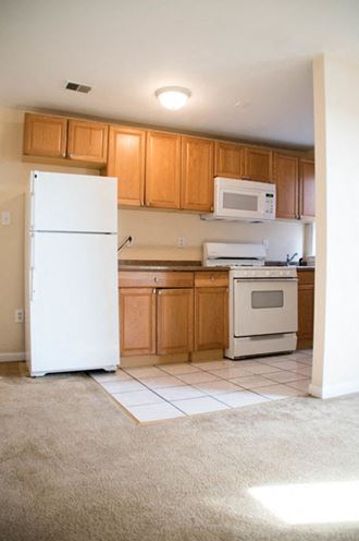 a small kitchen with a refrigerator and a microwave
