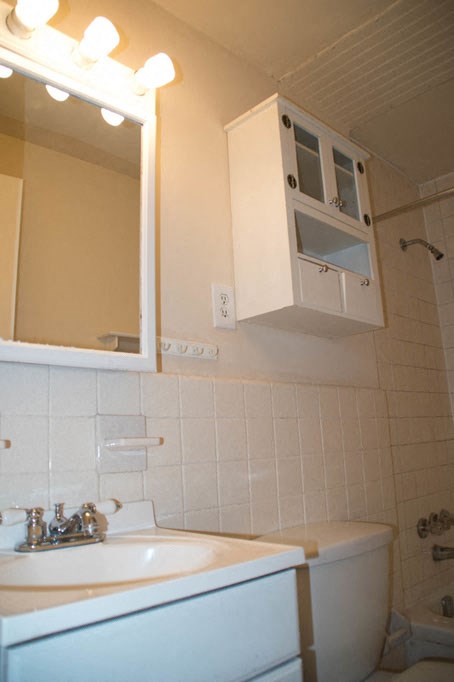 a bathroom with a sink and a mirror and a toilet