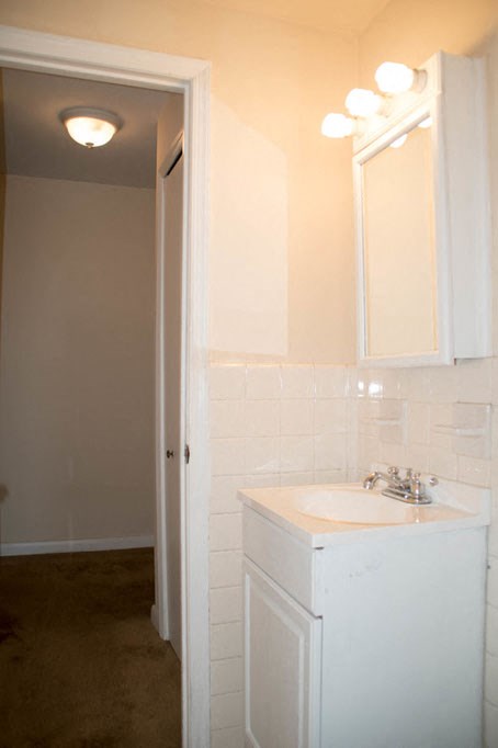 a white bathroom with a sink and a mirror