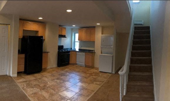 an empty kitchen with a staircase