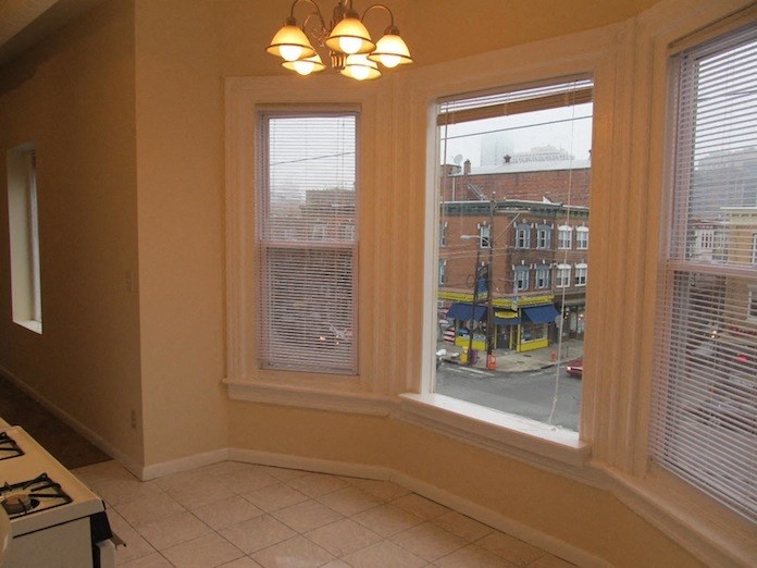 a view of a living room with three windows