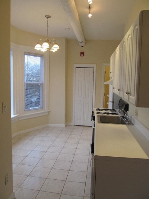 an empty kitchen with a sink and a door