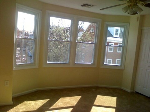 an empty living room with a bay window